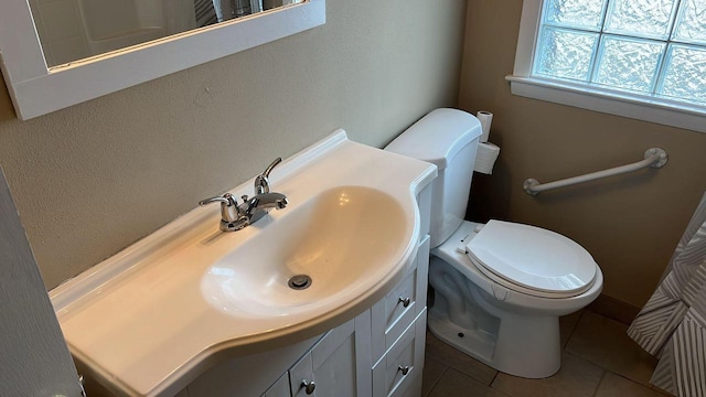 bathroom featuring tile patterned floors, vanity, and toilet