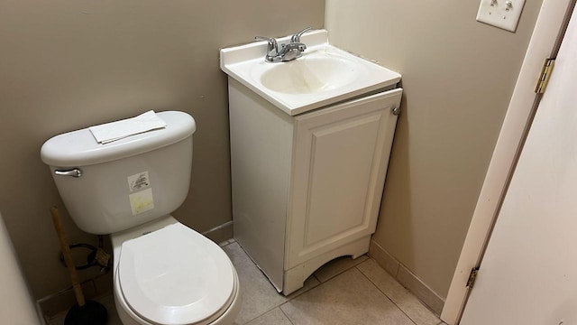 bathroom with tile patterned flooring, vanity, and toilet