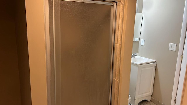 bathroom featuring tile patterned floors, vanity, and walk in shower