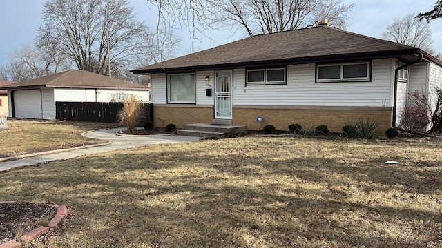 view of front facade with a garage, an outbuilding, and a front yard