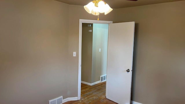 empty room featuring ceiling fan and light hardwood / wood-style flooring