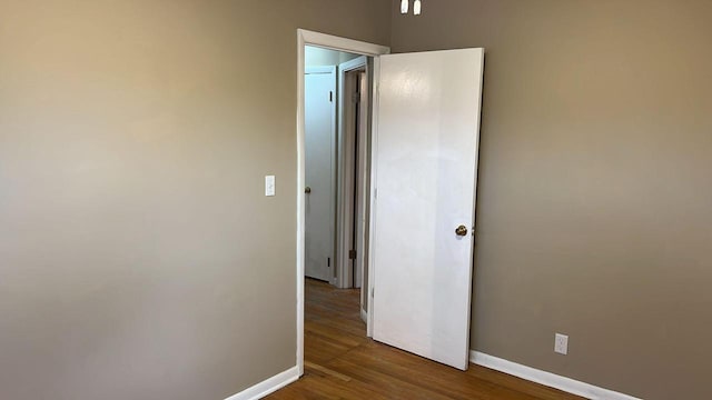 unfurnished room with hardwood / wood-style flooring