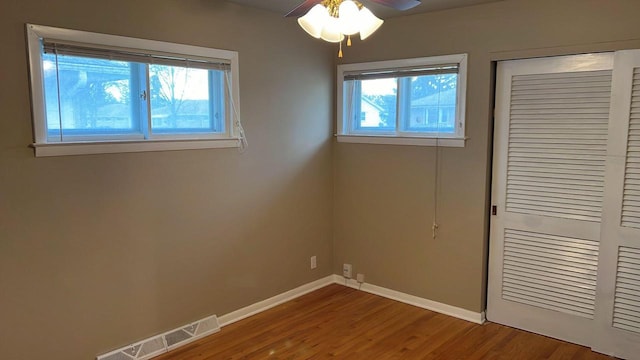 unfurnished bedroom with a closet, ceiling fan, and hardwood / wood-style floors