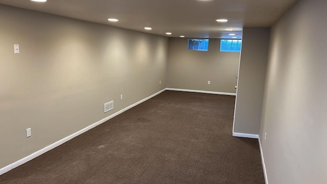 basement with dark colored carpet