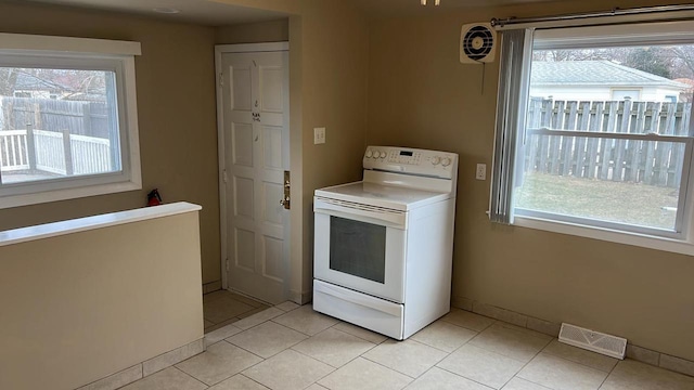 kitchen with white range with electric cooktop and light tile patterned flooring