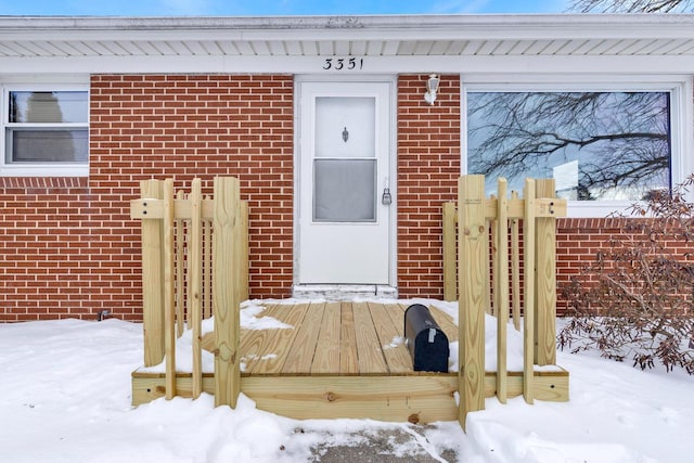 view of snow covered property entrance