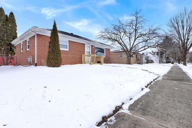 view of snow covered rear of property