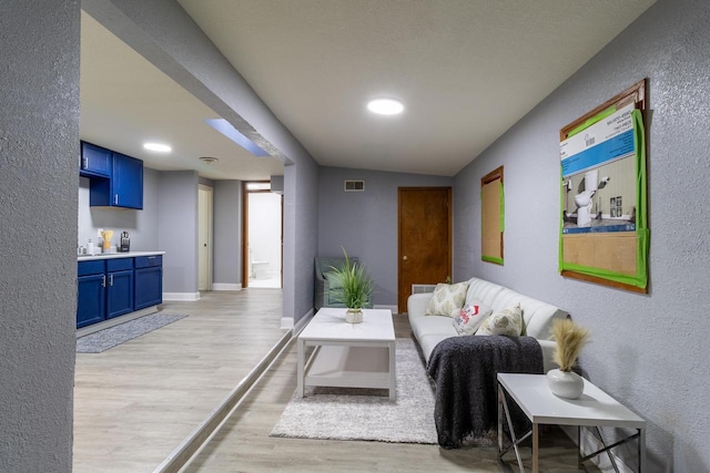 living room with vaulted ceiling and light wood-type flooring