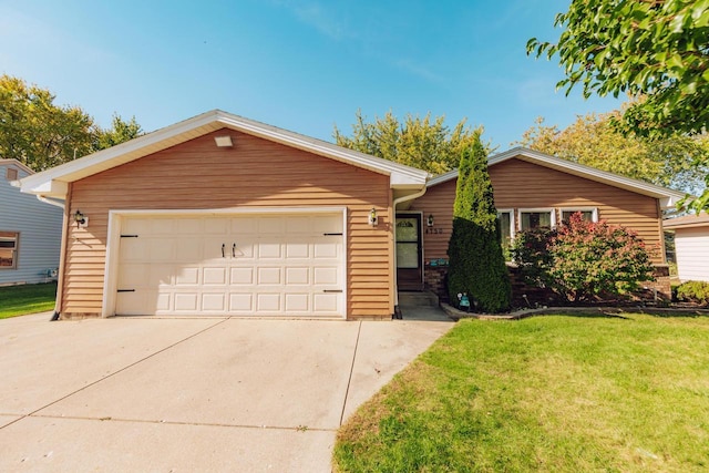 ranch-style house with a garage and a front lawn