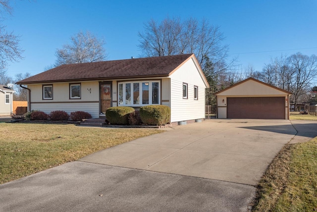 ranch-style home featuring an outbuilding, a front yard, and a garage