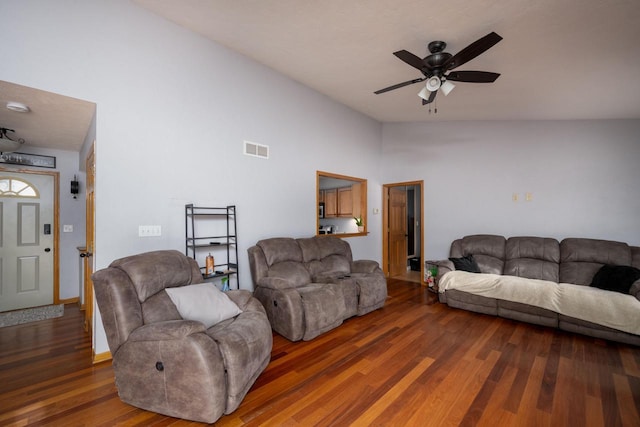 living room with ceiling fan and dark wood-type flooring