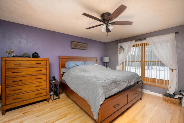 bedroom featuring access to outside, light hardwood / wood-style floors, and ceiling fan