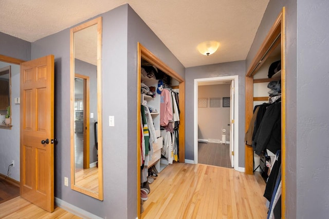 mudroom featuring a textured ceiling and hardwood / wood-style flooring