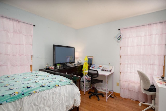 bedroom featuring light wood-type flooring and multiple windows