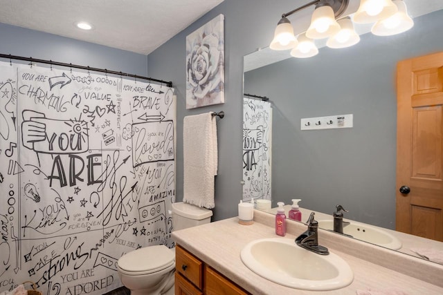 bathroom with a shower with curtain, vanity, toilet, and a textured ceiling