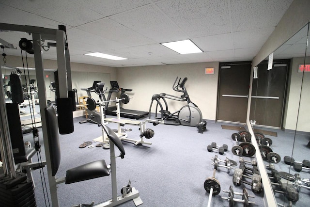 workout area with a paneled ceiling