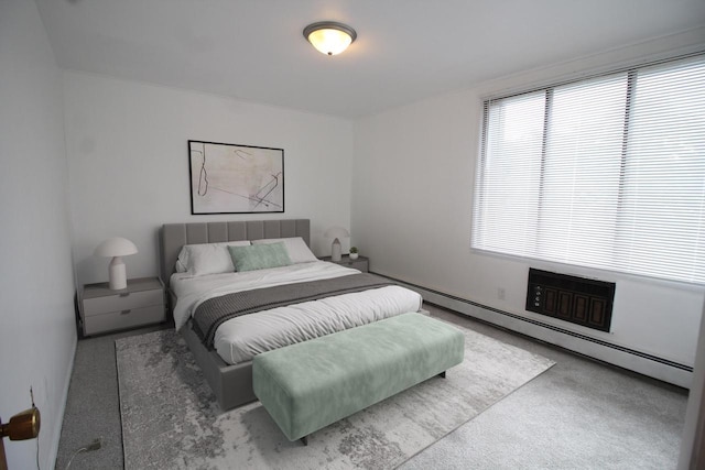 carpeted bedroom with multiple windows and a baseboard radiator