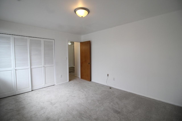 unfurnished bedroom with carpet and a closet