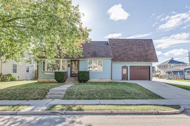 view of front of property featuring a garage and a front lawn