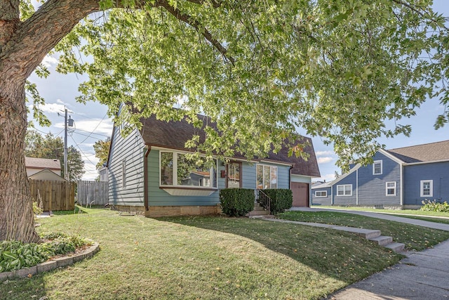 view of front of property featuring a garage and a front yard