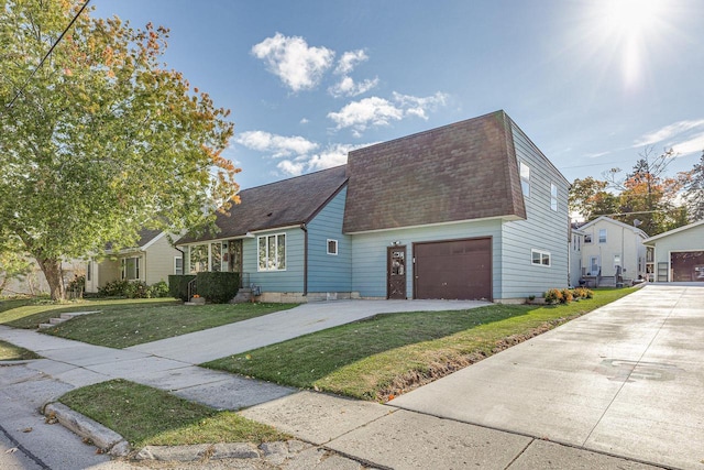 view of front of property featuring a garage and a front lawn