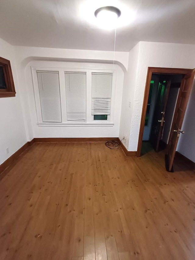 spare room with hardwood / wood-style floors