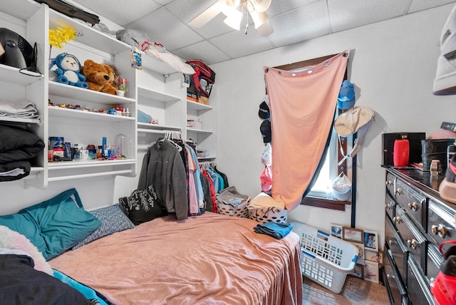 interior space with ceiling fan and a drop ceiling