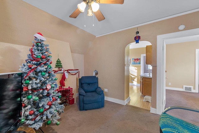 living area with carpet flooring, ceiling fan, and lofted ceiling