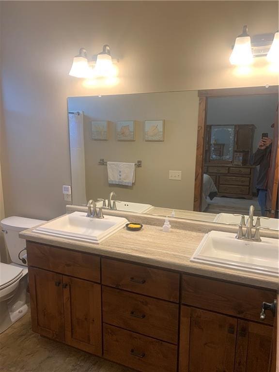 bathroom featuring vanity and toilet