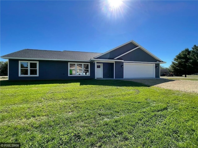 single story home featuring a garage and a front lawn