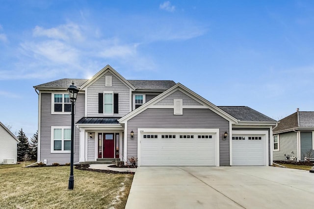 view of front of house featuring a front yard and a garage