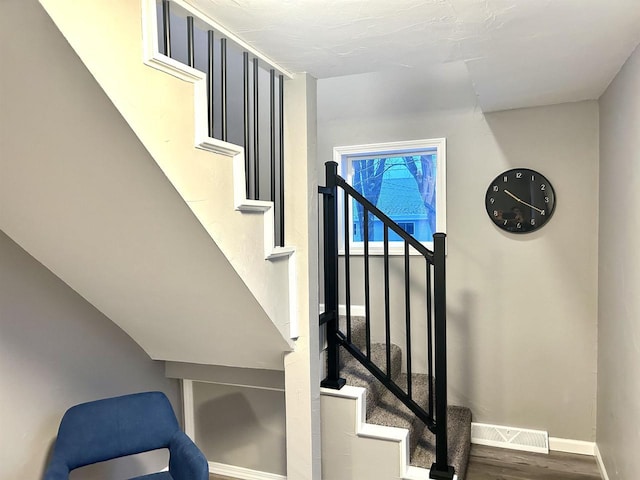 stairway with hardwood / wood-style flooring