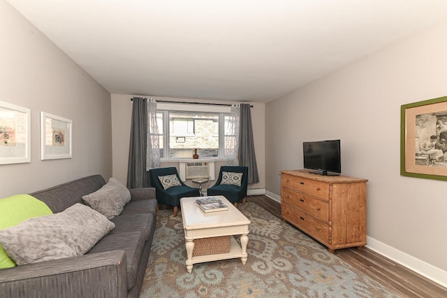 living room featuring dark hardwood / wood-style flooring and a baseboard heating unit