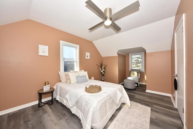 bedroom with ceiling fan, dark hardwood / wood-style floors, and lofted ceiling