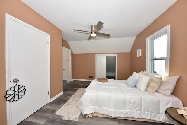 bedroom with ceiling fan, dark hardwood / wood-style floors, and vaulted ceiling