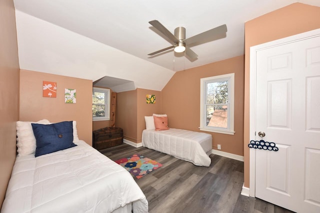 bedroom with ceiling fan, dark hardwood / wood-style floors, and vaulted ceiling