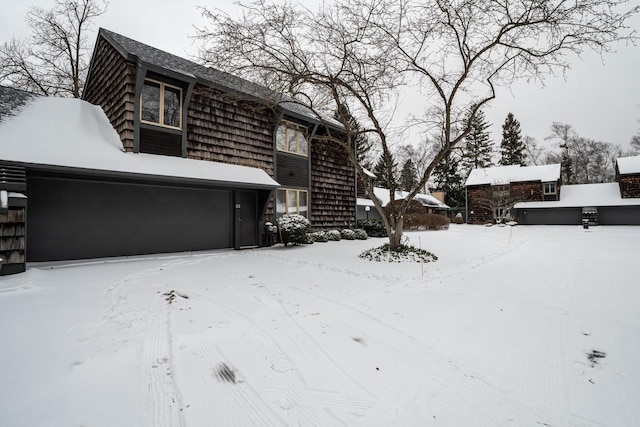 snowy yard with a garage