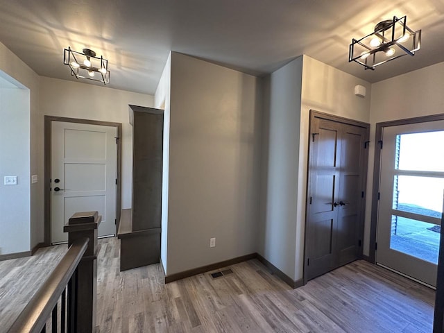 foyer featuring an inviting chandelier and light hardwood / wood-style floors