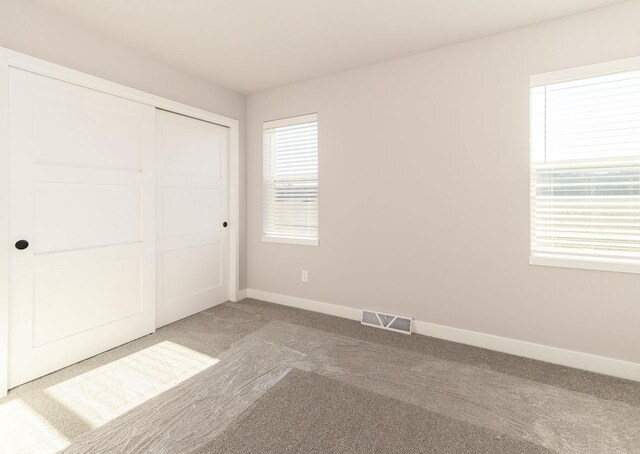 3620 Angelus Way, Cross Plains, WI 53528 - unfurnished bedroom featuring a closet, carpet, baseboards, and visible vents