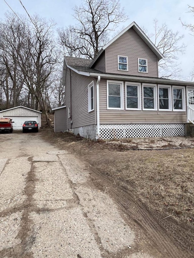 exterior space featuring an outbuilding and a garage