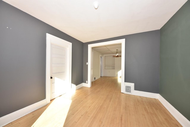 interior space featuring light wood-type flooring and an inviting chandelier