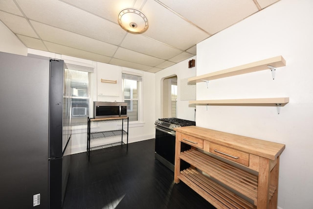 kitchen featuring white cabinets, appliances with stainless steel finishes, and a paneled ceiling