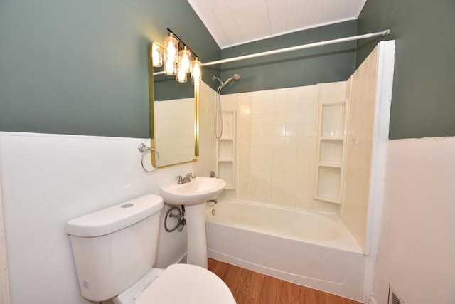 bathroom with shower / bath combination, toilet, and wood-type flooring