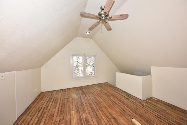 additional living space with wood-type flooring, vaulted ceiling, and ceiling fan