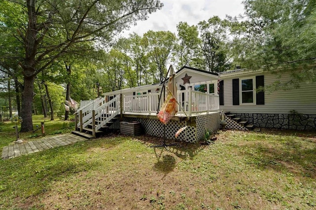 rear view of property with a deck and a lawn