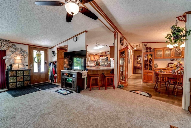 living room featuring ornamental molding, carpet floors, lofted ceiling, and a notable chandelier