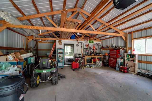 garage with a workshop area and a garage door opener