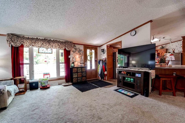 living room featuring a textured ceiling, carpet, vaulted ceiling, and ornamental molding