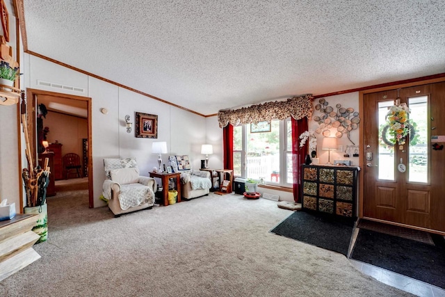 interior space featuring vaulted ceiling, carpet floors, a textured ceiling, and ornamental molding