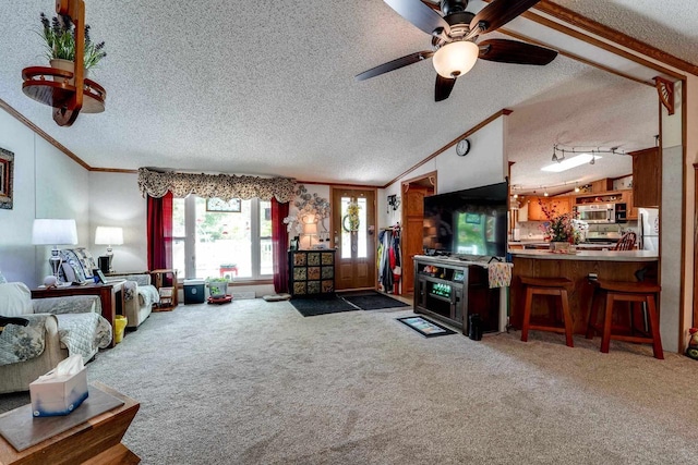 carpeted living room with ceiling fan, a textured ceiling, and vaulted ceiling